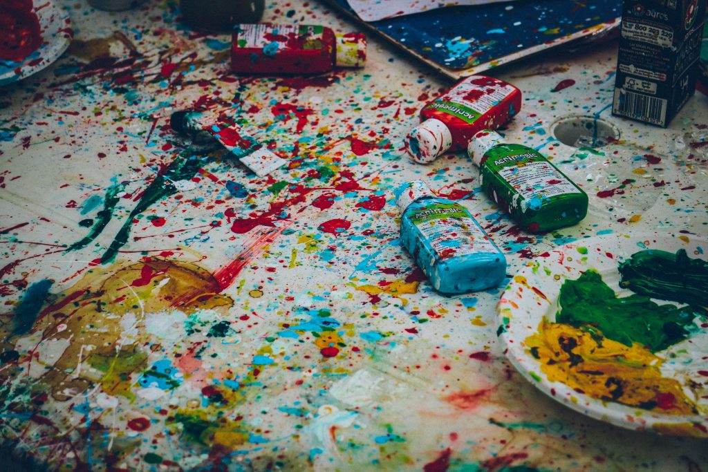 Colorful messy art workspace with paint